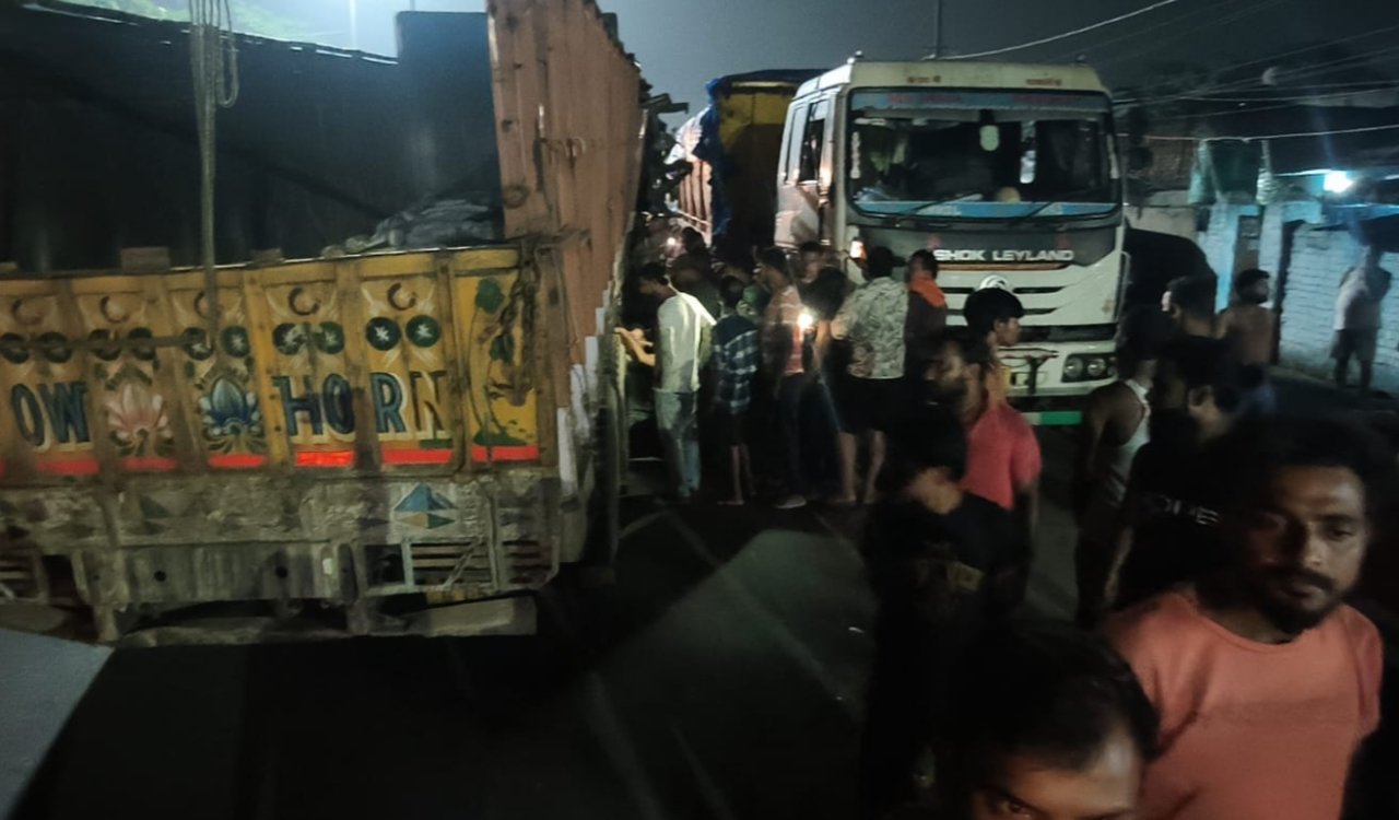 Head-on collision between a truck and a tipper-trailer in Ramgarh; driver trapped in the cabin, rescued after an hour.