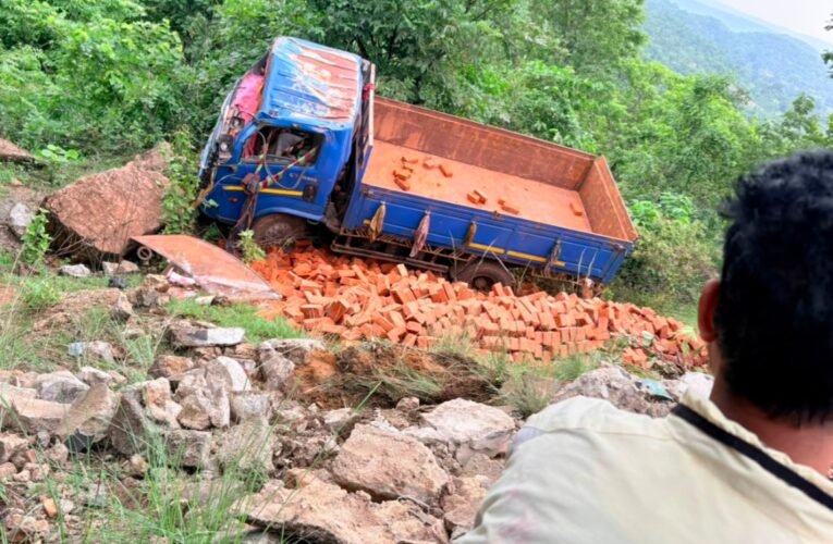 Brick-laden truck crashes in Pithoria Valley; driver flees, helper injured.
