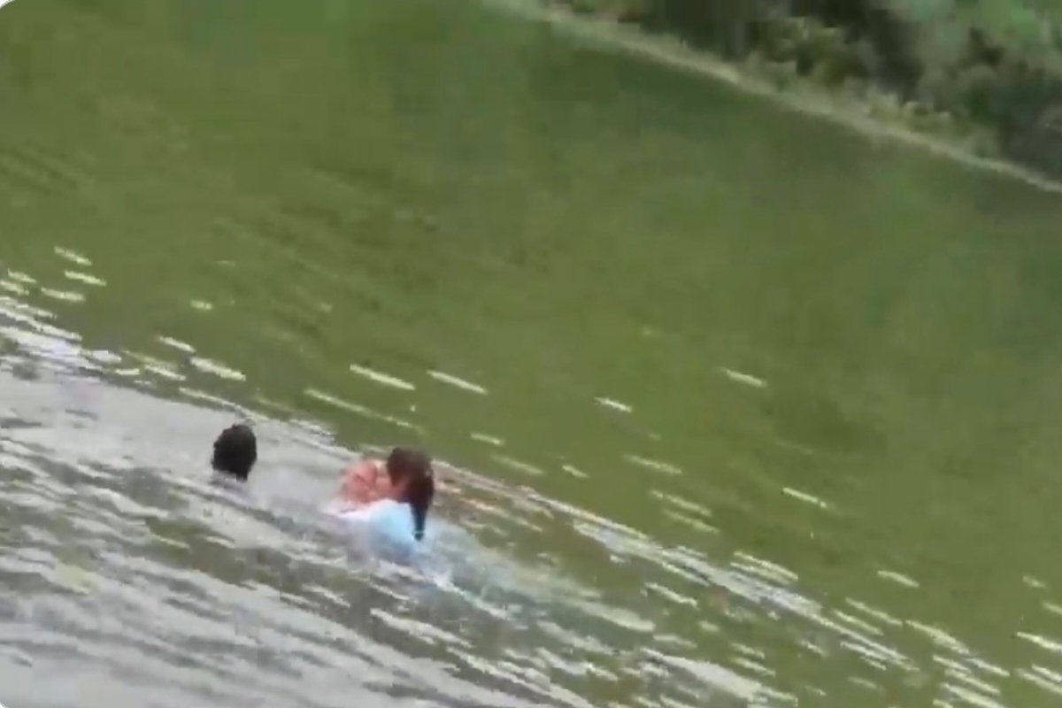Principal seen bathing in the dam with female students.