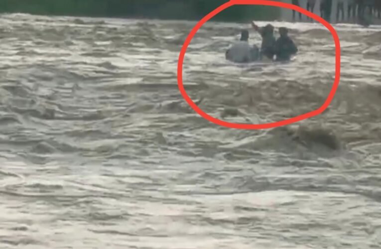 Three youths stranded in the strong currents of the Gerua River in Chatra.