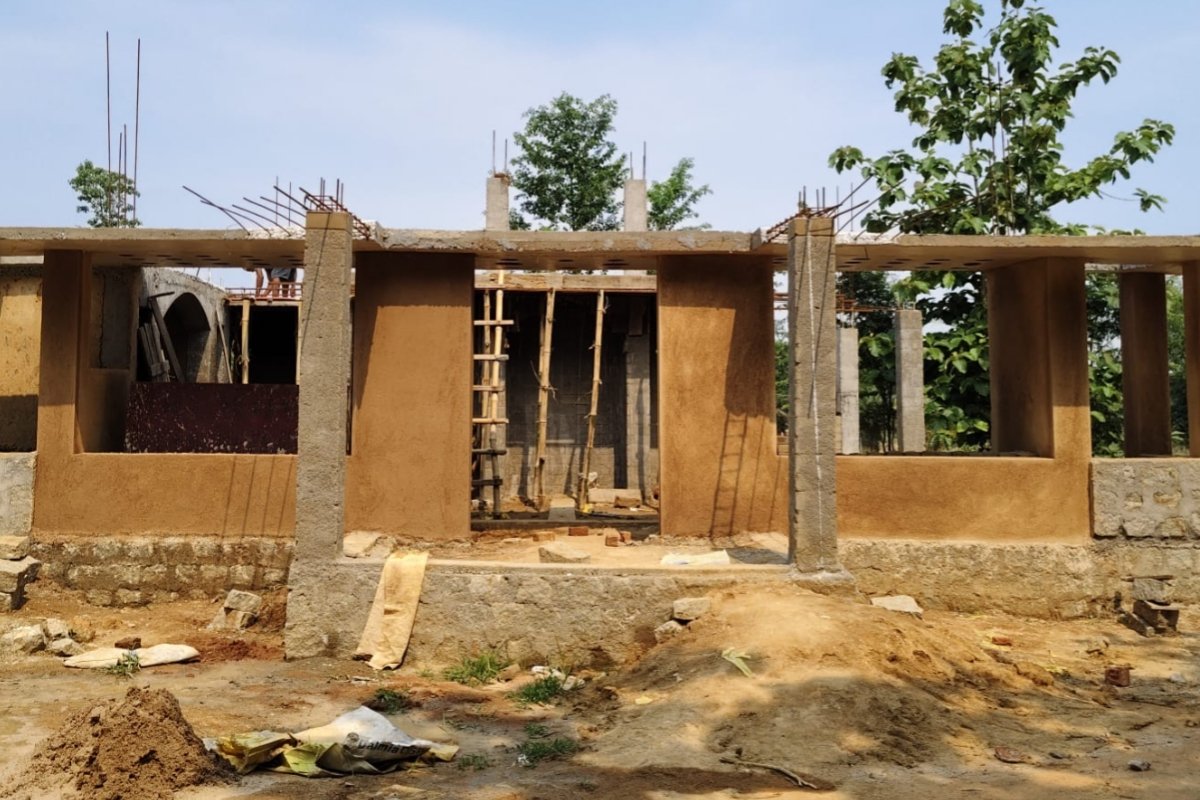 An 80-year-old mother's final dream lies within unfinished walls—the hope for a roof of her own on her native soil—with her future home stalled by a land dispute.