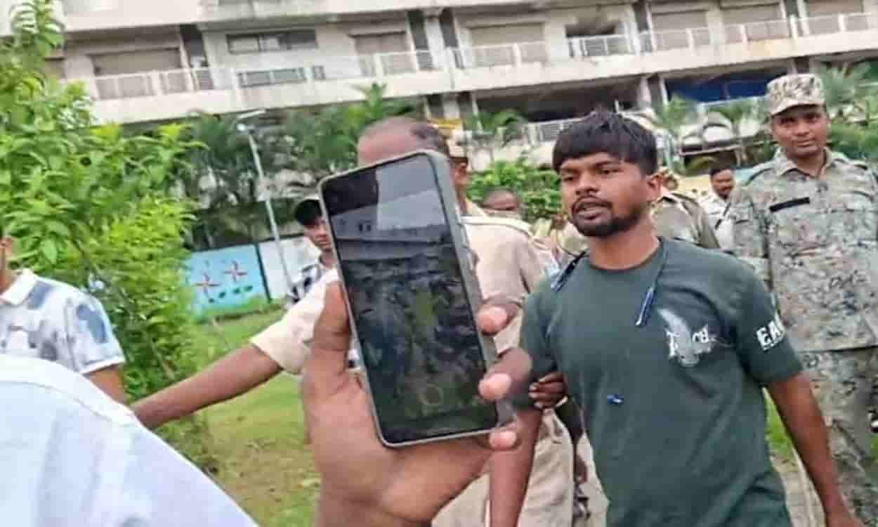 Youth climbs mobile tower near Jaipal Singh Munda Stadium amidst JPSC protest.