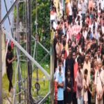 Youth climbs mobile tower to protest against corrupt system.