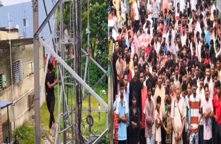 Youth climbs mobile tower to protest against corrupt system.