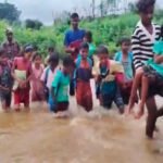 Children's journey to school across a swollen river in Chatra.