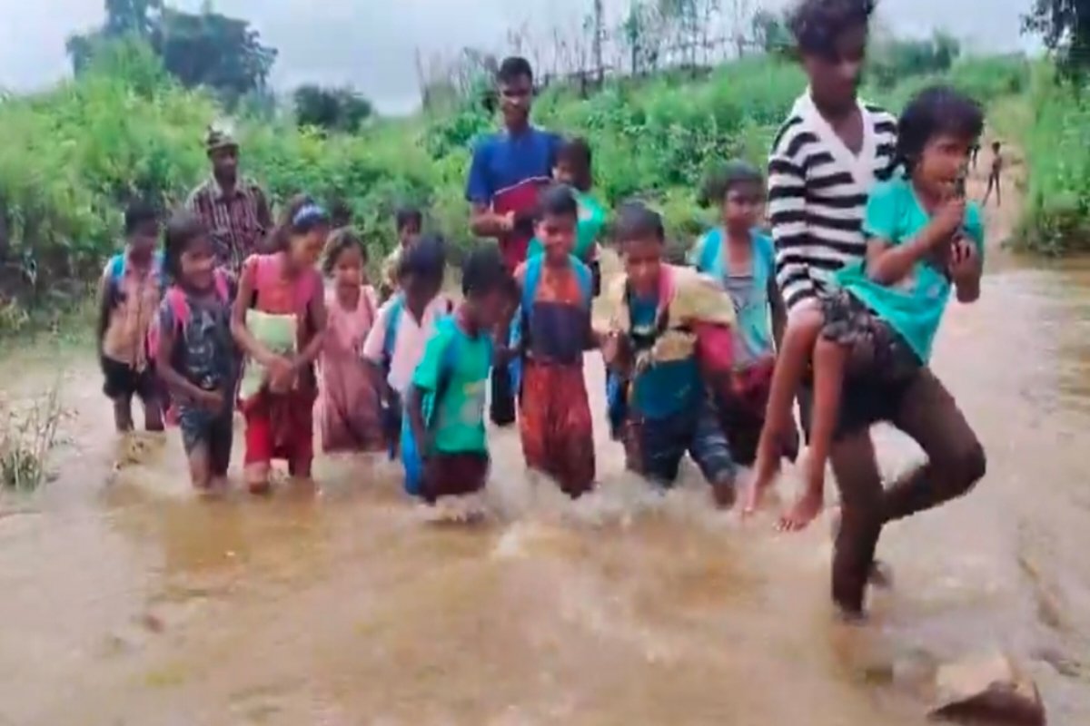 Children's journey to school across a swollen river in Chatra.