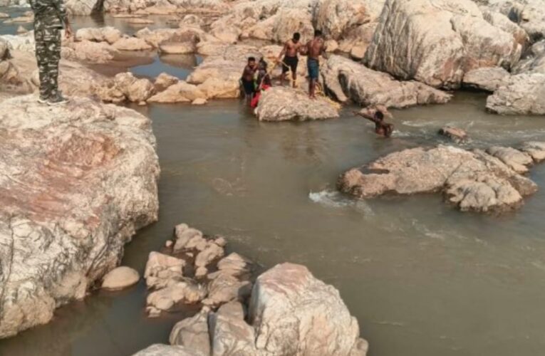 woman-trapped-rock-amidst-deep-water